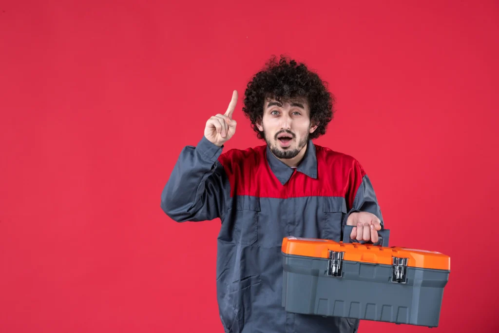 front view male worker with tool case red background photo color worker mechanic house instrument job emotion uniform