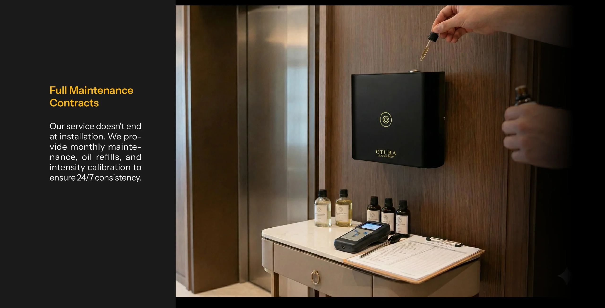 A technician's hands refilling a wall-mounted black Otura scent diffuser with a glass dropper, with maintenance tools, oil bottles, and a service clipboard on the table below.